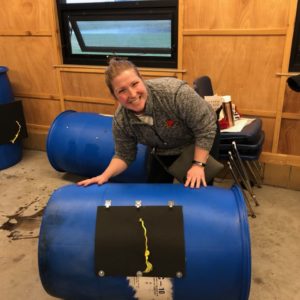 woman posing with an assembled compost tumbler