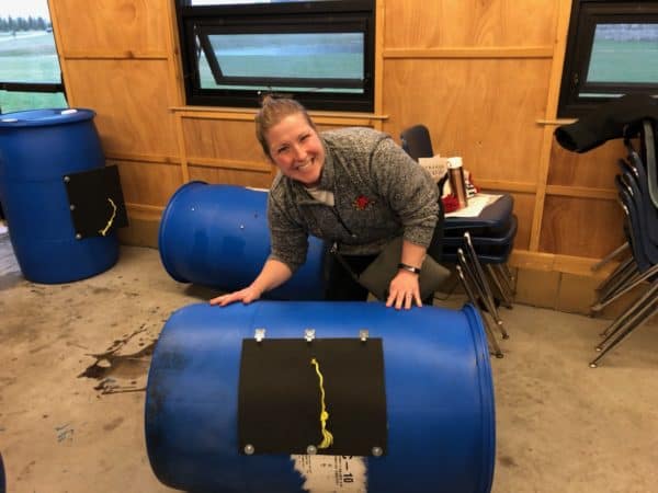 woman posing with an assembled compost tumbler